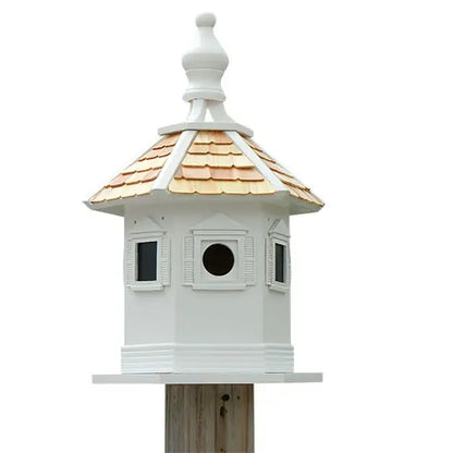 White birdhouse with a decorative roof on a white background